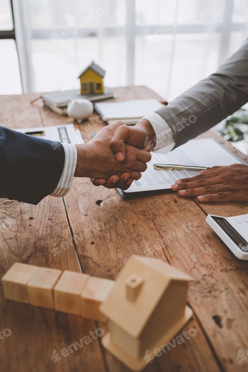 Preview: Real estate broker and client shaking hands after signing sale contract, home loan and congratulatin