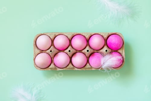 Preview: Easter elements, paper box with eggs in pink colors on pastel green background.