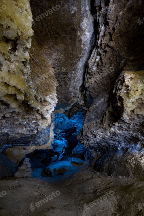 Preview: Interior of the cave with blue light and crystal. Tourist hiking route. Ancient formations of stone