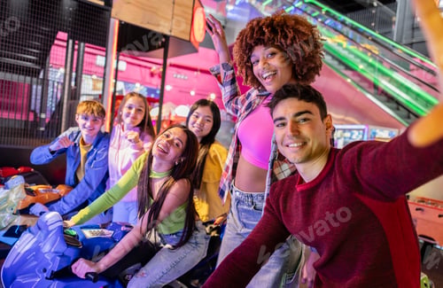 Preview: Group of Friends Taking a Selfie at Arcade After Racing Game