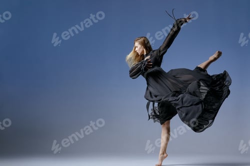 Preview: Elegant woman dancing in black dress, frozen mid-movement in artistic contemporary studio shot.