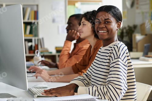 Preview: Smiling Woman Working at Office Desk with Colleagues