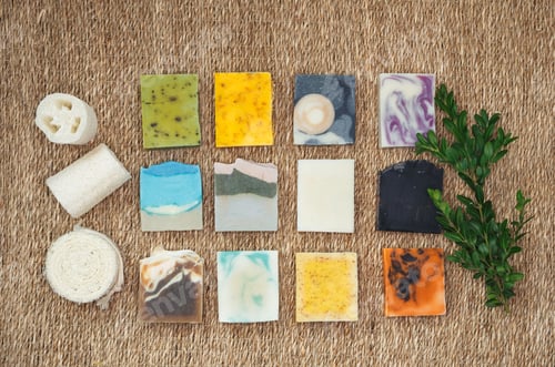 Preview: Stacks homemade bars of soap with herbal material and plants extracts