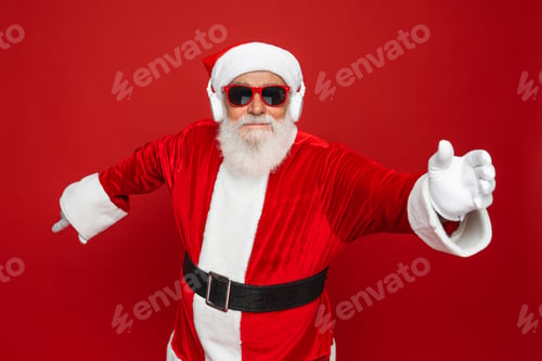Preview: Santa claus dance raise hands in sunglasses wireless headphone listen music having fun isolated