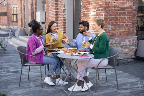 Preview: Friends Dining Outdoors With Pizza