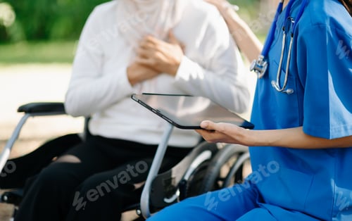 Preview: Elderly asian senior woman on wheelchair with Asian careful caregiver and encourage patient, walking
