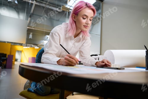 Preview: Architect working in office, making notes on the project
