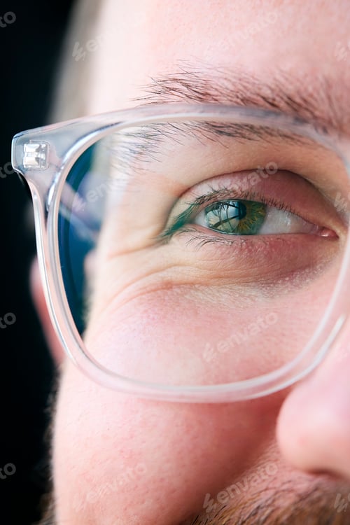 Preview: Macro Studio Expression Shot Of Young Man's Eye Wearing Glasses With Close Up On Eyelashes And Pupil