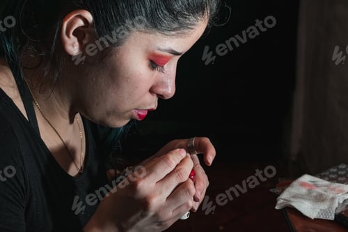 Preview: girl checking her worn lipstick. woman looking carefully at her damaged make-up