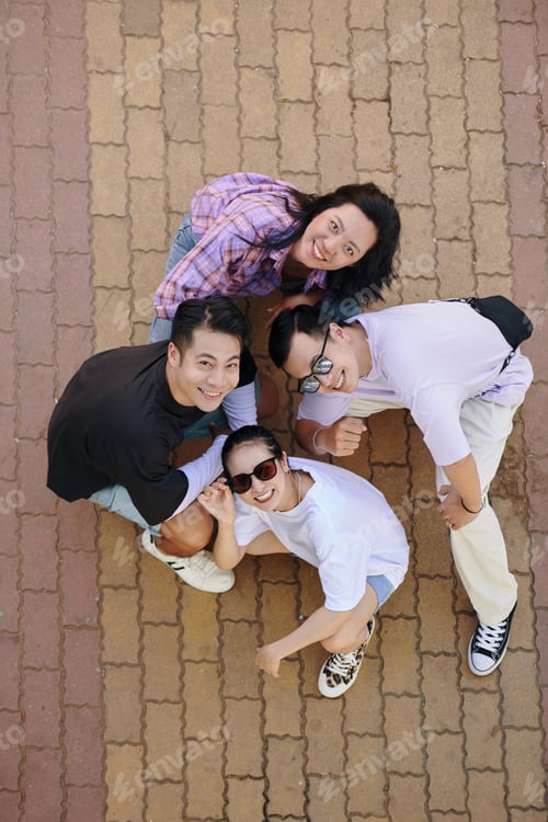 Preview: Top View of Friends Smiling Upwards