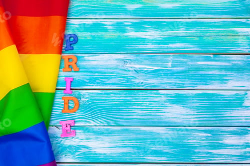 Preview: Gay pride flag on wooden table. creative photo