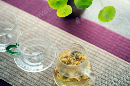 Herbal Tea Being Poured at Indoor Setting