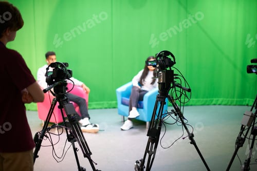 Preview: Young male and female college students practicing in TV studio with green screen