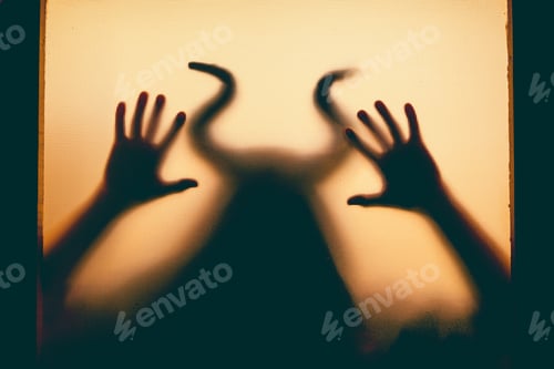 Preview: Horror, halloween background - Shadowy figure with horns behind the glass