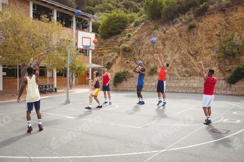 Preview: Basketball players practicing in basketball court
