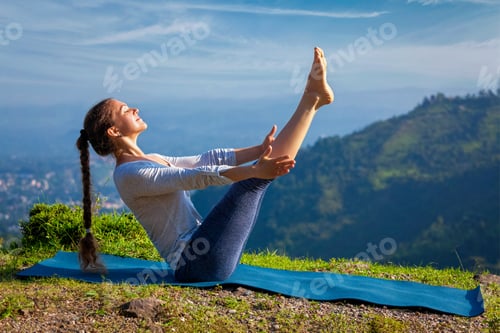 Preview: Woman doing Ashtanga Vinyasa Yoga asana Navasana - boat pose