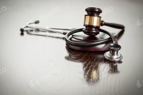 Preview: Gavel and Stethoscope on Reflective Table