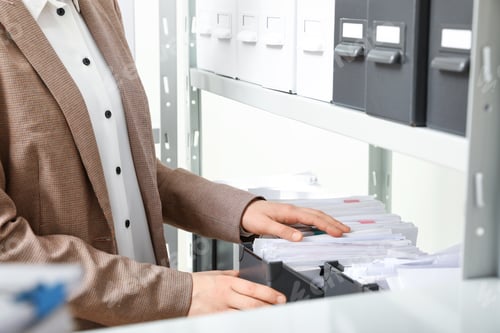 Preview: Woman taking documents from folder in archive, closeup