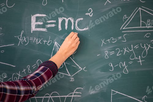 Preview: Teacher or student writing on blackboard during math lesson in school classroom