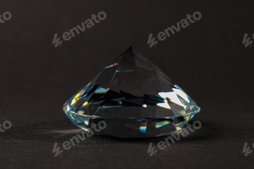 Preview: Beautiful dazzling diamond on dark background, closeup. Precious gemstone
