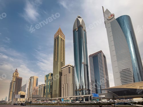 Preview: Modern skyscrapers towering against a clear blue sky in a bustling cityscape
