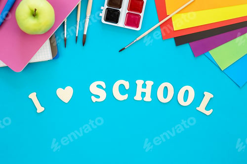 Preview: Colourful school supplies on a blue background, back to school concept.