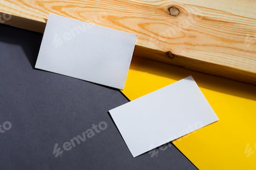 Preview: Business card with place for text. Background from yellow and gray paper lying diagonally.