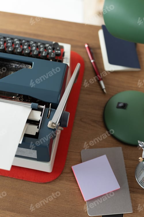 Preview: Vintage old typewriter at wooden desk table. Writer or screenwriter concept