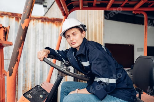 Preview: Portrait of woman forklift driver in factory,.