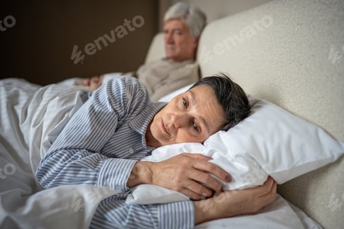 Preview: Rejected distressed wife turning away from husband in bed, emotional disconnect, relationship crisis
