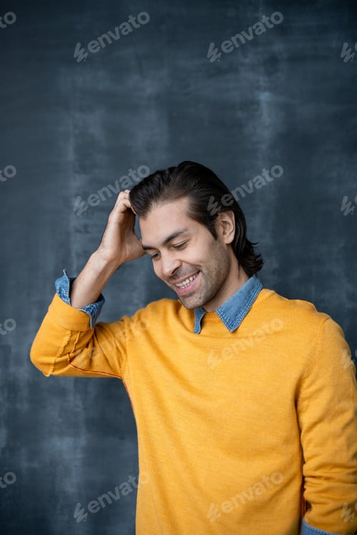 Preview: Smiling man scratching head