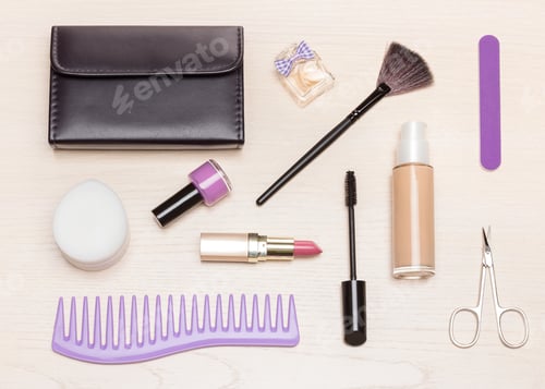 Preview: Basic contents of cosmetic bag on light wood table, flat lay. Essential make-up beauty products
