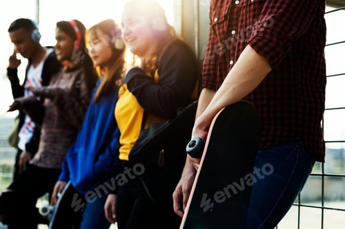 Preview: Group of school friends outdoors lifestyle and music leisure concept