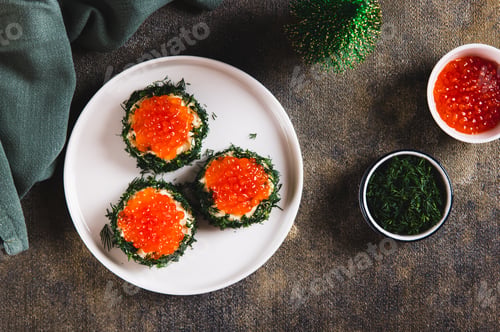 Preview: Original small sandwiches with butter and red caviar on a plate on the table top view