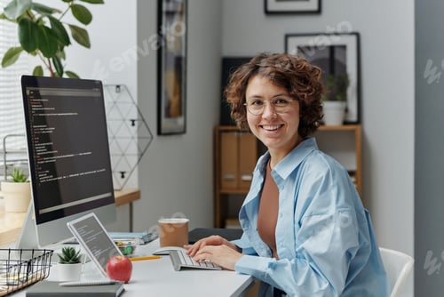 Preview: Female developer working on computer at office