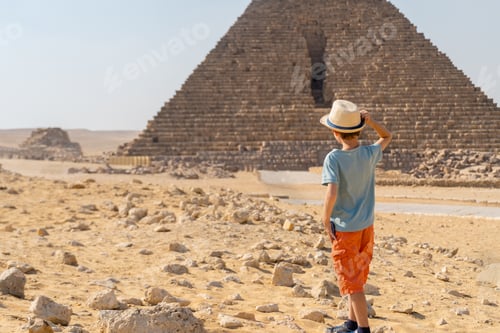 Preview: Boy walking in front of the pyramid of Mikerin on the Giza plateau