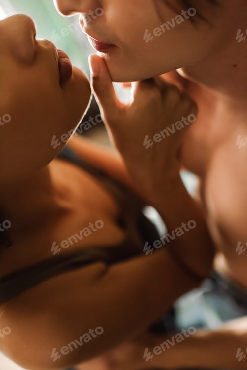 Preview: cropped view of sexy african american woman touching face of young shitless man in art studio