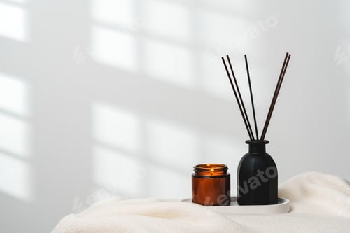 Preview: Elegant Aroma Diffuser With Reed Sticks And Scented Candle On White Tablecloth