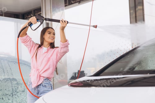 Preview: Young Woman Smiling While Washing Car at a Self-Service Station