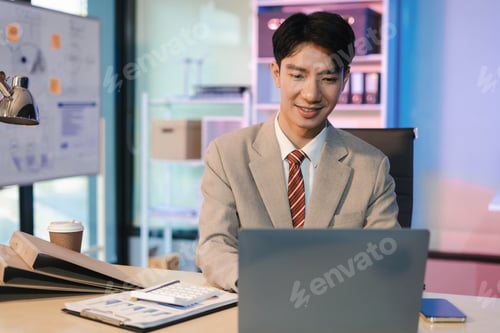 Preview: Business man working at office with laptop and documents on desk