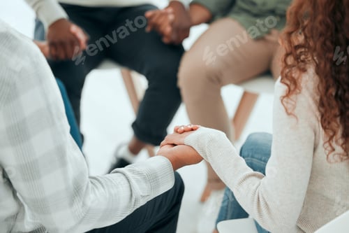 Preview: Cropped shot of an unrecognisable group of people sitting together and holding hands during prayer