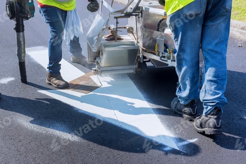 Preview: Worker thermoplastic spray marking machine painting work on the street