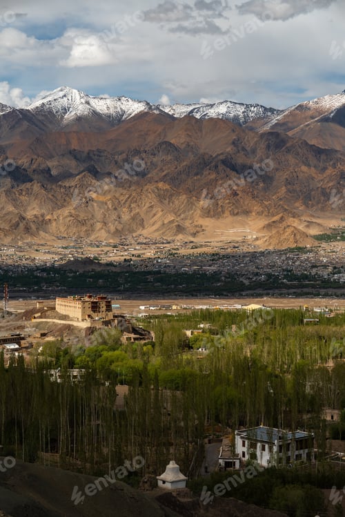 Preview: Mountain landscape valley town snow mountain dry hill green valley monastery view dramatic sky