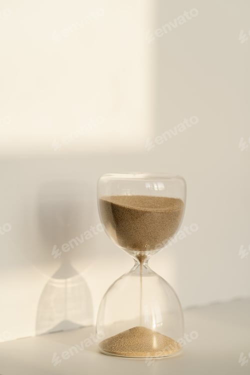 Preview: Transparent hourglass on a white sunny background.