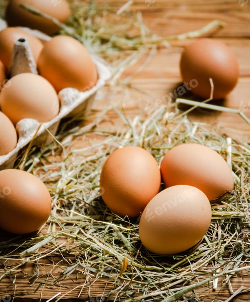 Preview: Chicken eggs on wooden table.
