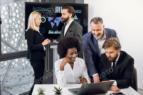 Preview: Positive purposeful multiracial business colleagues, working together over joint business project