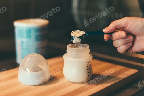Preview: Mother making baby formula in milk bottle