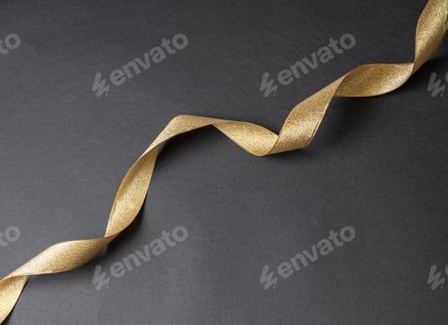 Preview: Golden ribbon curl on black color background. Minimal card template