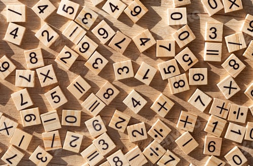 Preview: Scattered wooden plaques with numbers and signs. Flat lay. Teaching material in mathematics.