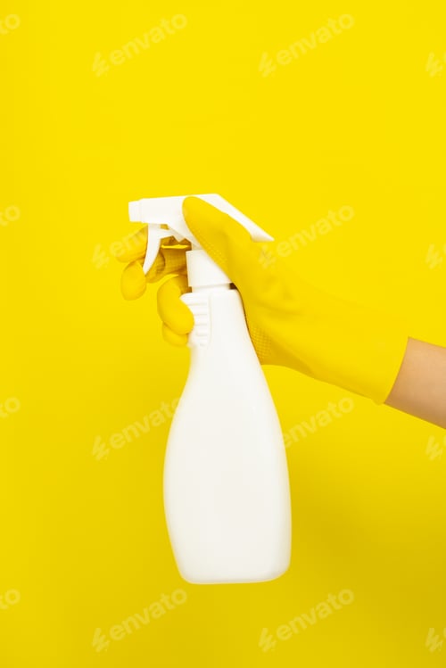Preview: Gloved Hand Holding a Spray Bottle on Yellow